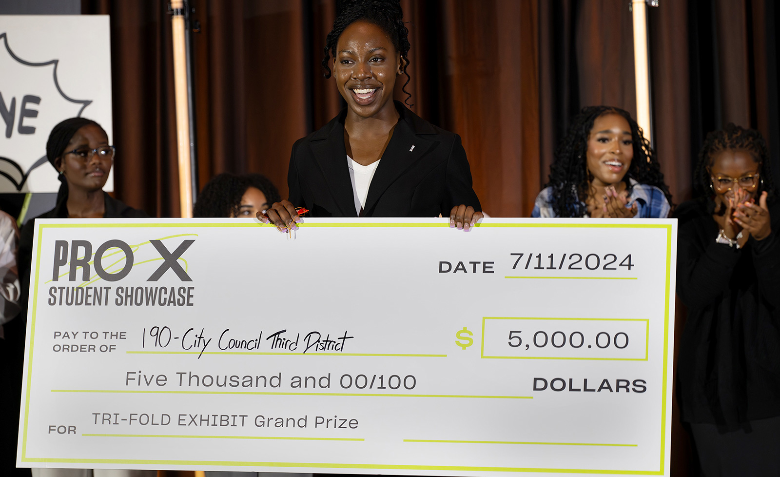 ProX summer interns hold a life-sized check at the ProX showcase
