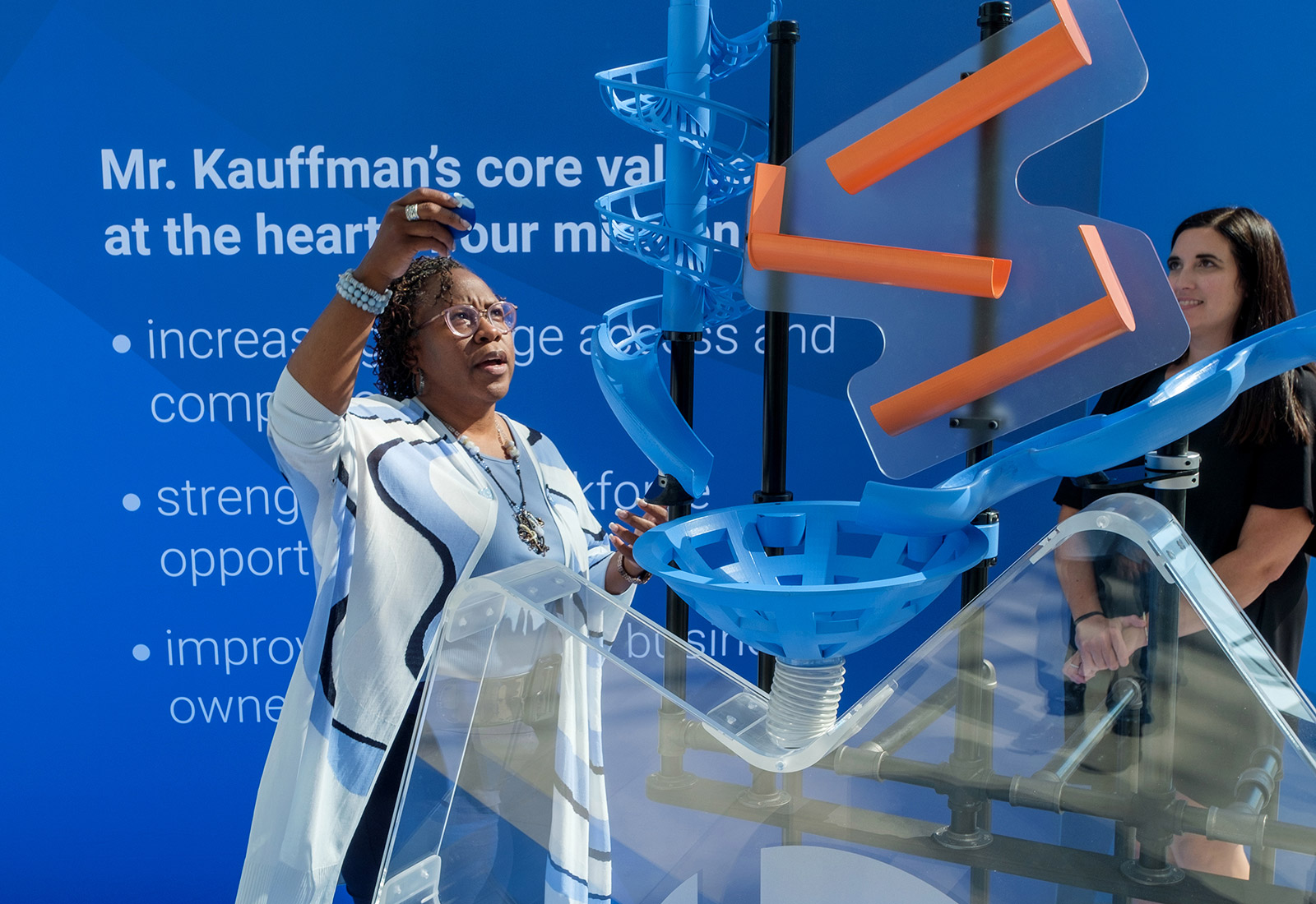 Dr. DeAngela Burns-Wallace, president and CEO of the Kauffman Foundation, drops her big idea into the acrylic heart at TEDxKC