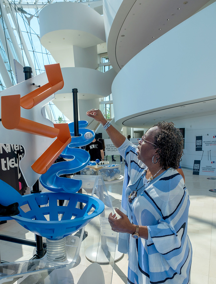 Dr. DeAngela Burns-Wallace, president and CEO of the Kauffman Foundation, drops her big idea into the acrylic heart at TEDxKC