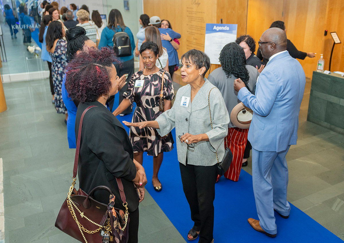 Community members walk the blue carpet at the Ewing Marion Kauffman Foundation Spark Open House event