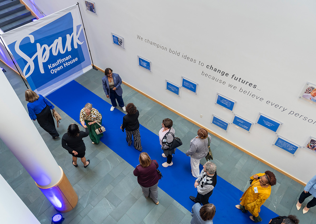 Community members walk the blue carpet at the Ewing Marion Kauffman Foundation Spark Open House event