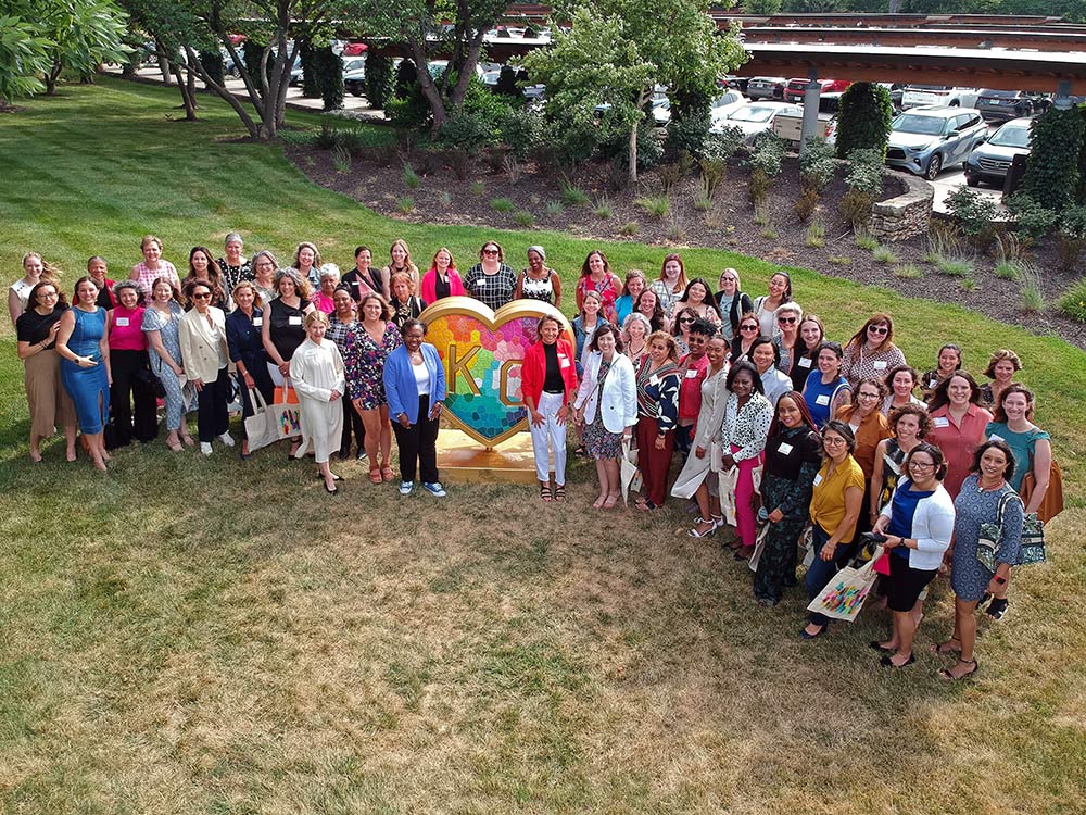 Kauffman associates pose for a photo with United WE staff next to the KC heart located at the Kauffman Foundation.